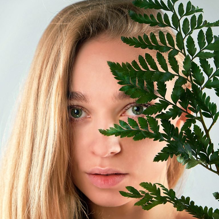 Closeup portrait of beauty woman spa green leaf, asia face perfect healthy glow skin, asian beautiful girl. Beauty clinic skincare organic natural spring earth day environment concept banner.